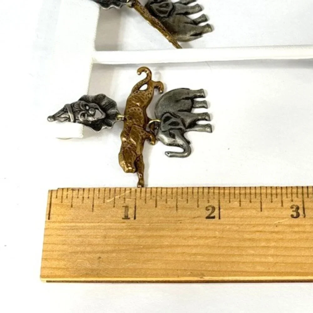 Silver- and gold-tone animal earrings w/ leopard and elephant.